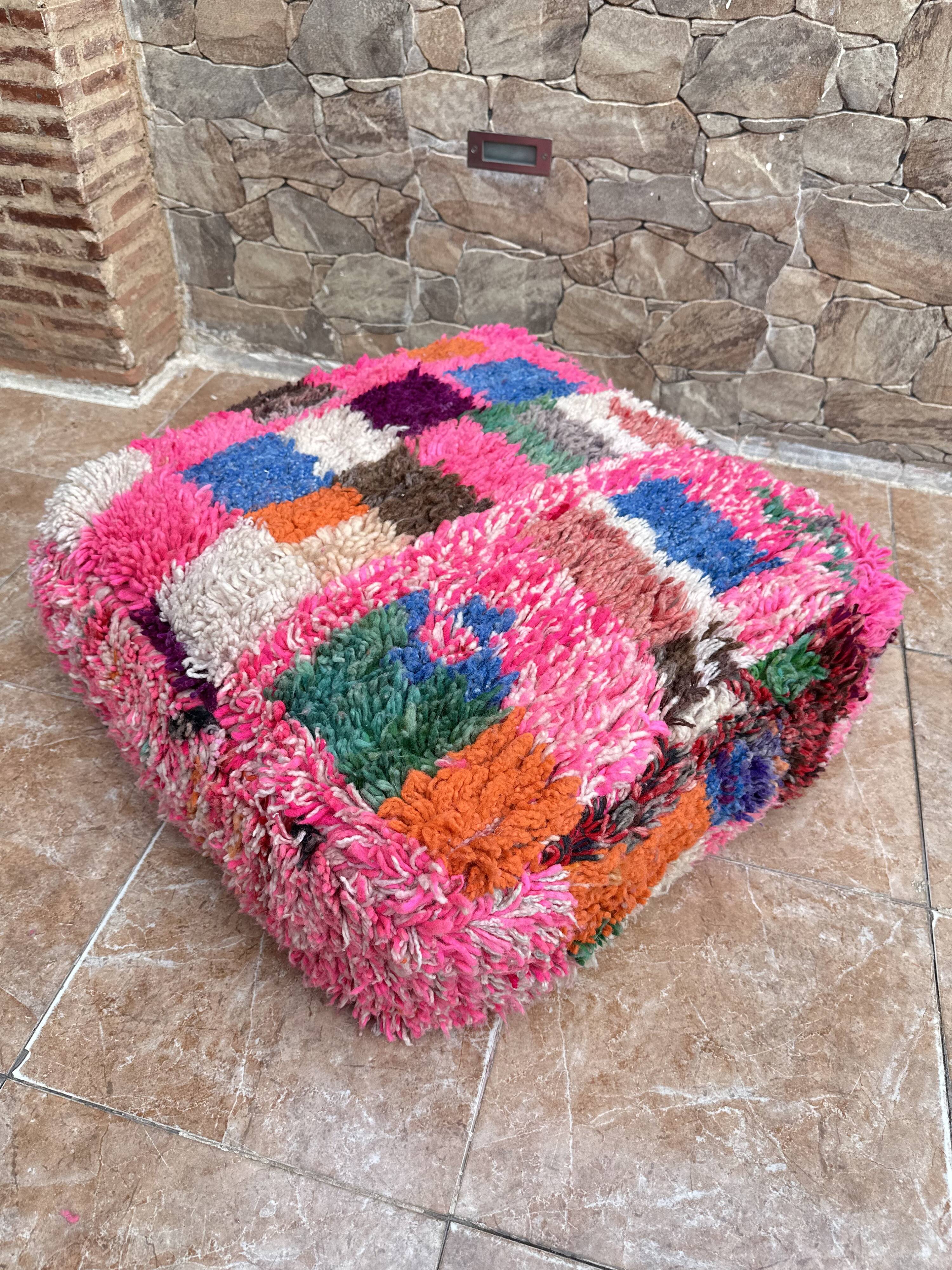 Berber floor pouf: Handwoven Moroccan wool cushion.