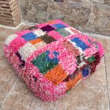 Berber floor pouf: Handwoven Moroccan wool cushion.