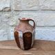 Old small pitcher in glazed terracotta