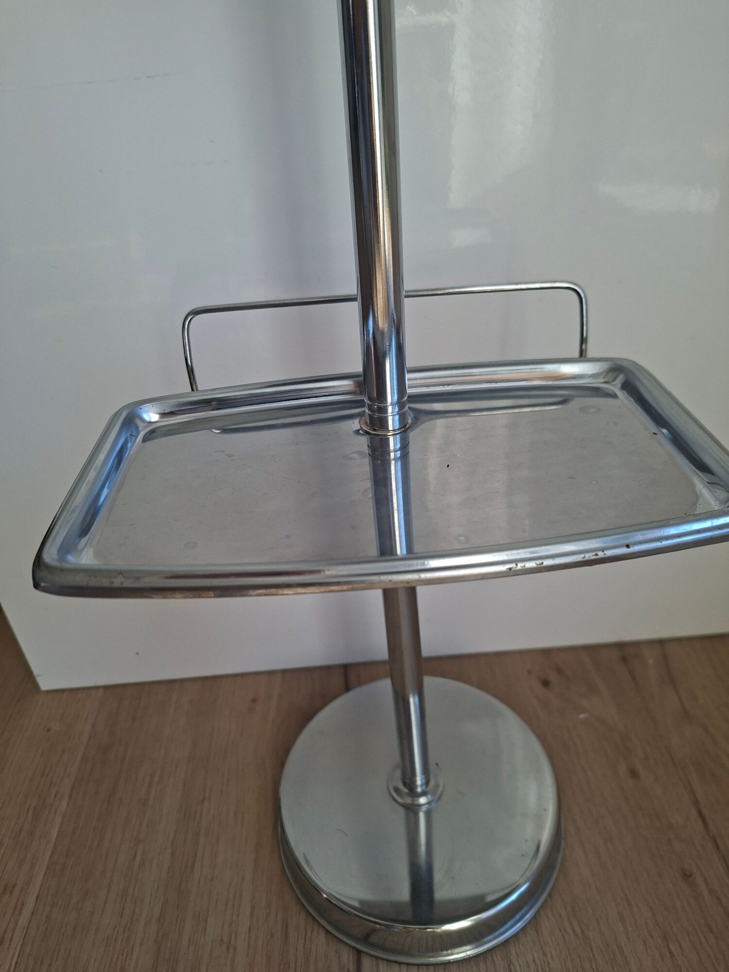 Vintage chrome metal floor ashtray with integrated tray.