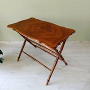 Vintage folding table with turned legs.