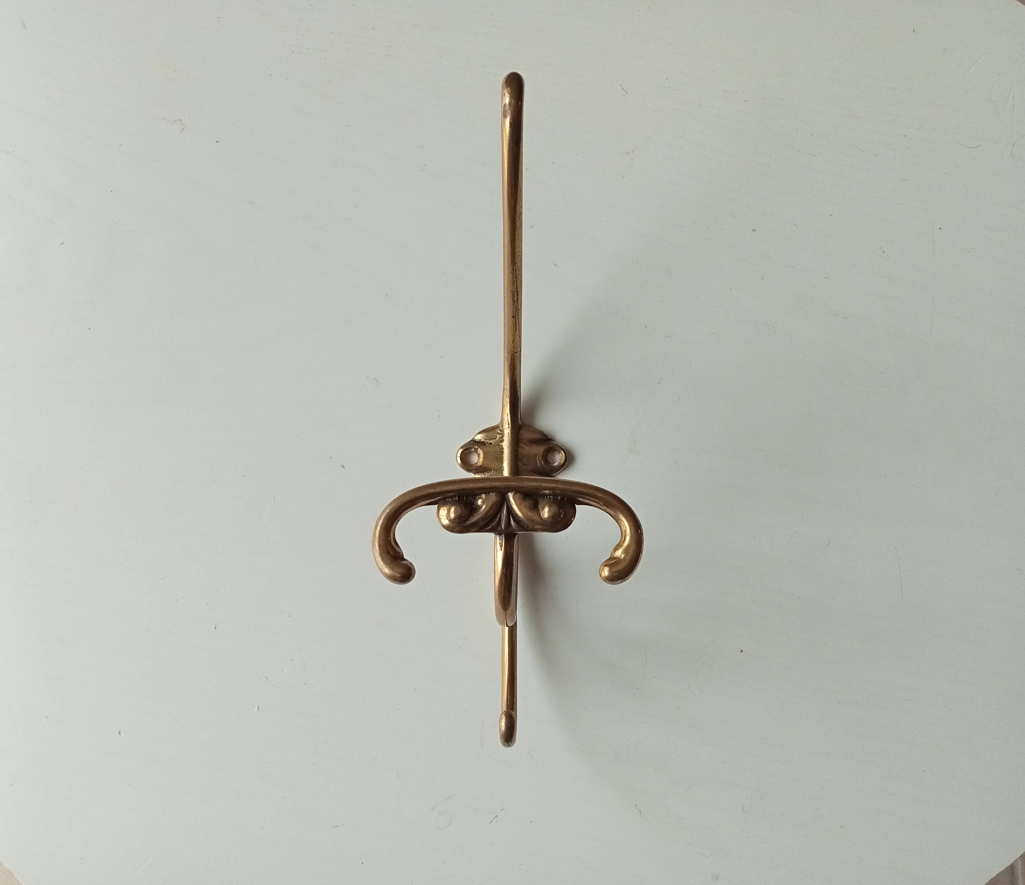 Old coat hook in solid golden brass