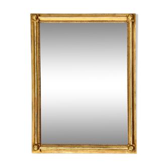 Neoclassical mirror in solid wood and gilded stucco with beaded frieze decoration