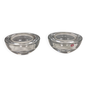 A set of iittala candle holders in clear transparent glass.