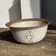 Small thick stoneware bowl with a stylised flower pattern in white on the outside, b