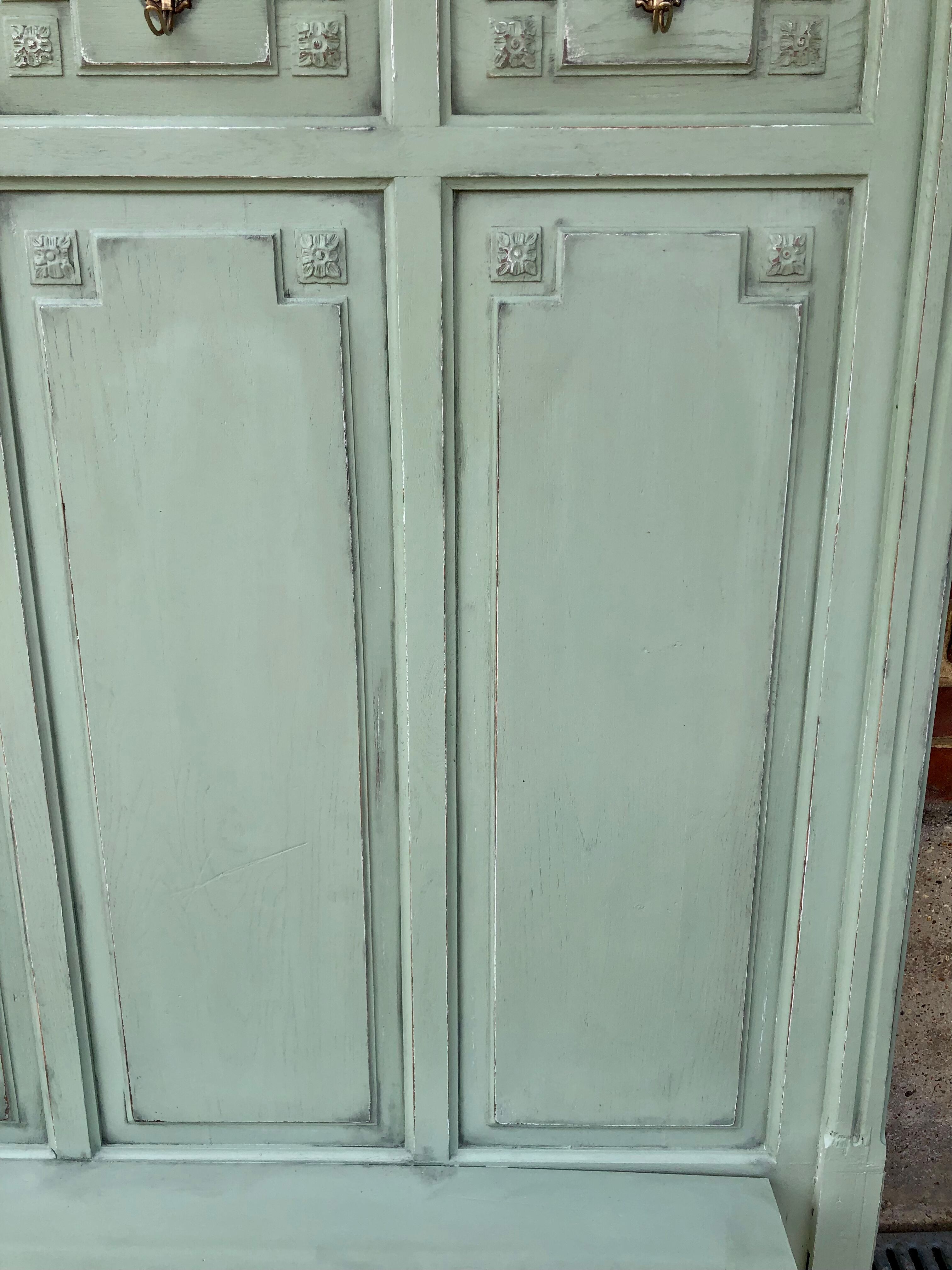 Cloakroom with sage green wall coats