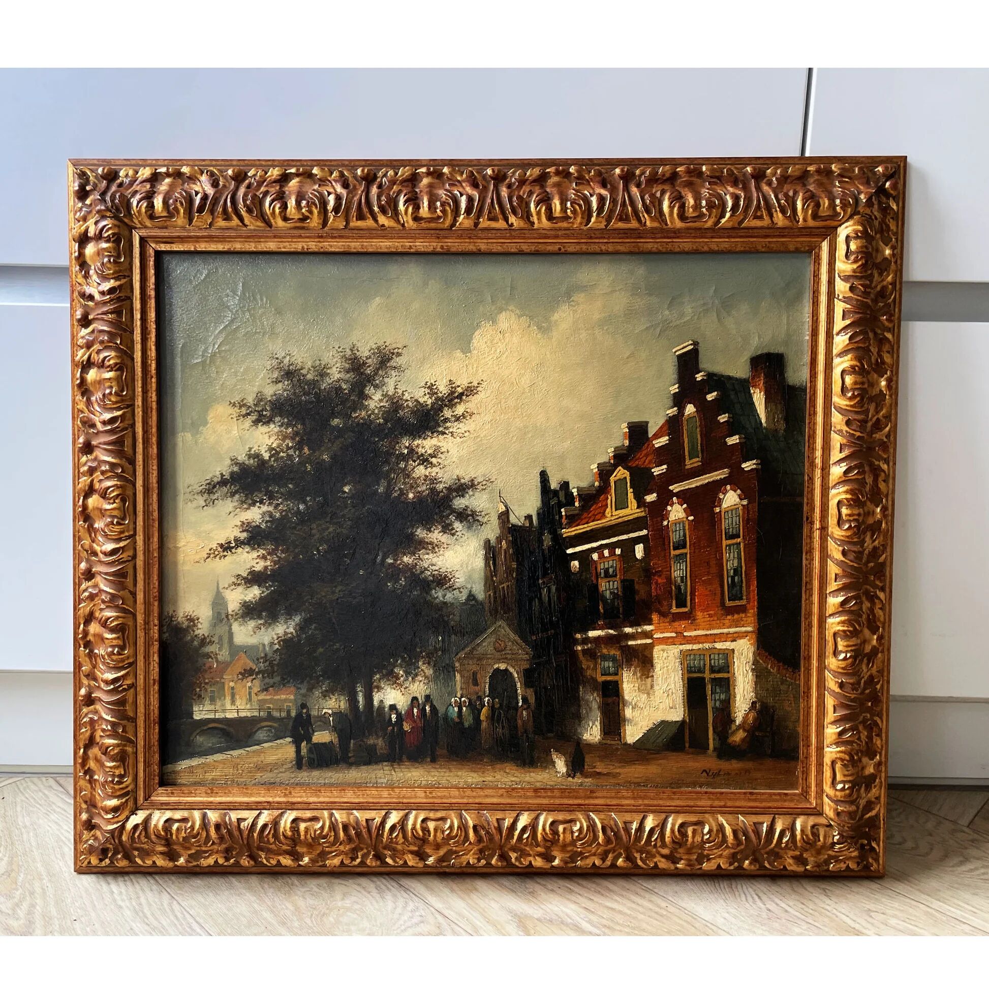 Dutch street scene oil painting in ornate frame signed Nijland