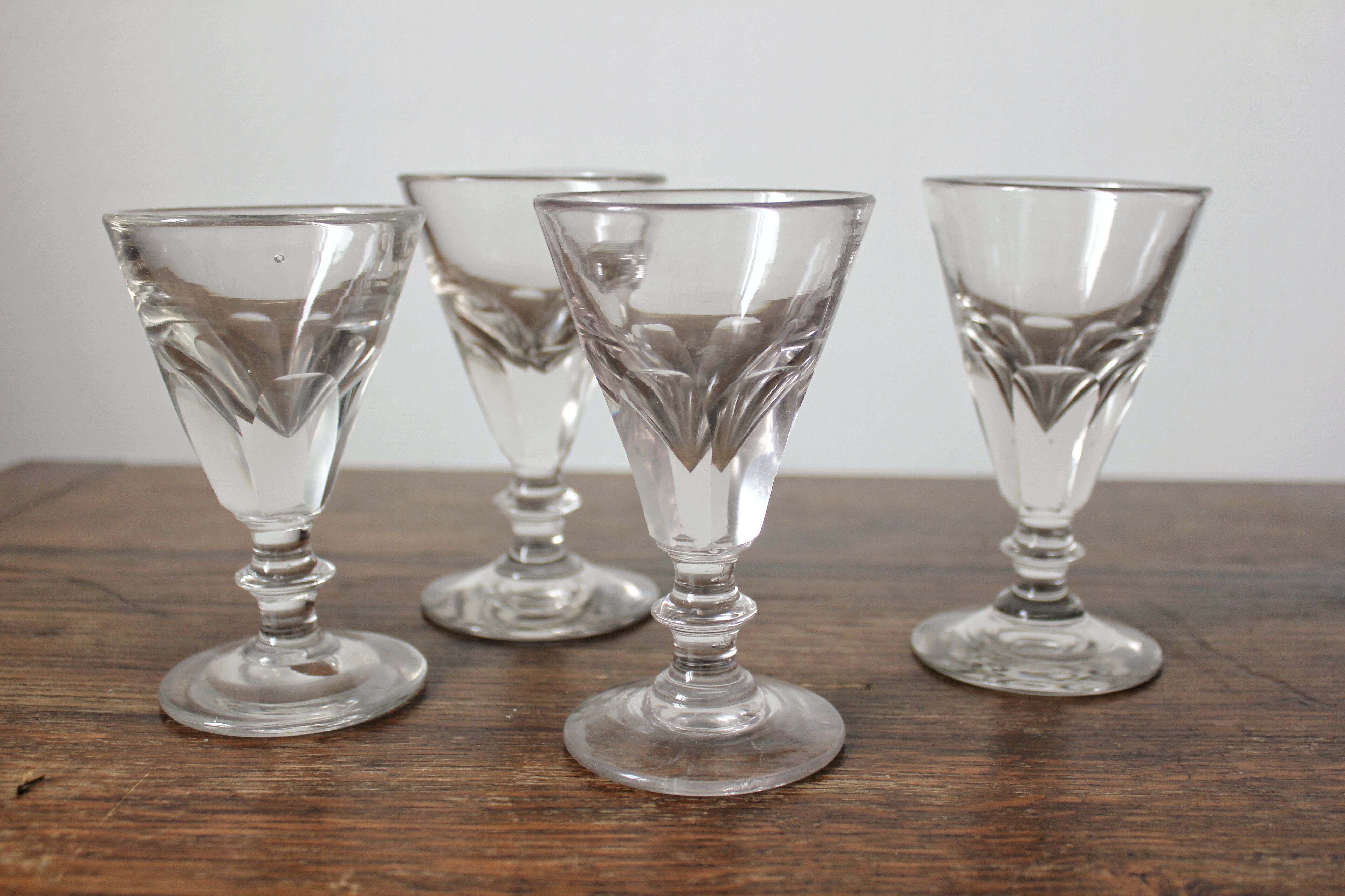 4 antique stemmed wine glasses with flat sides, made of blown glass from the 19th century