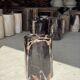 Black petrified wood side table with beige stripes, star pattern H35 D24.