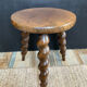 Antique tripod stool made of turned wood
