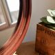 Round vintage mirror with mahogany wood effect frame.