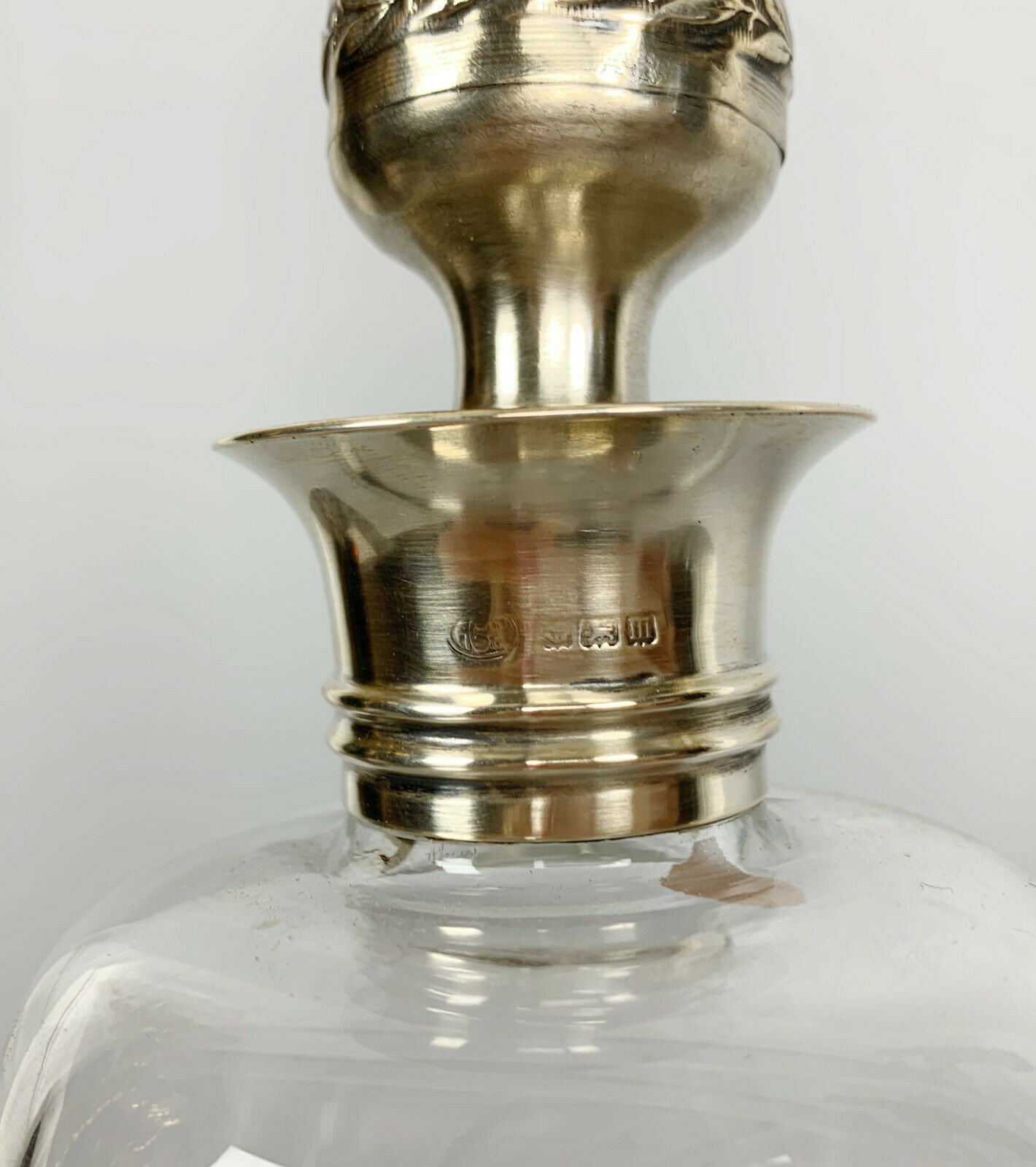 Blown glass carafe with silver frame and cap