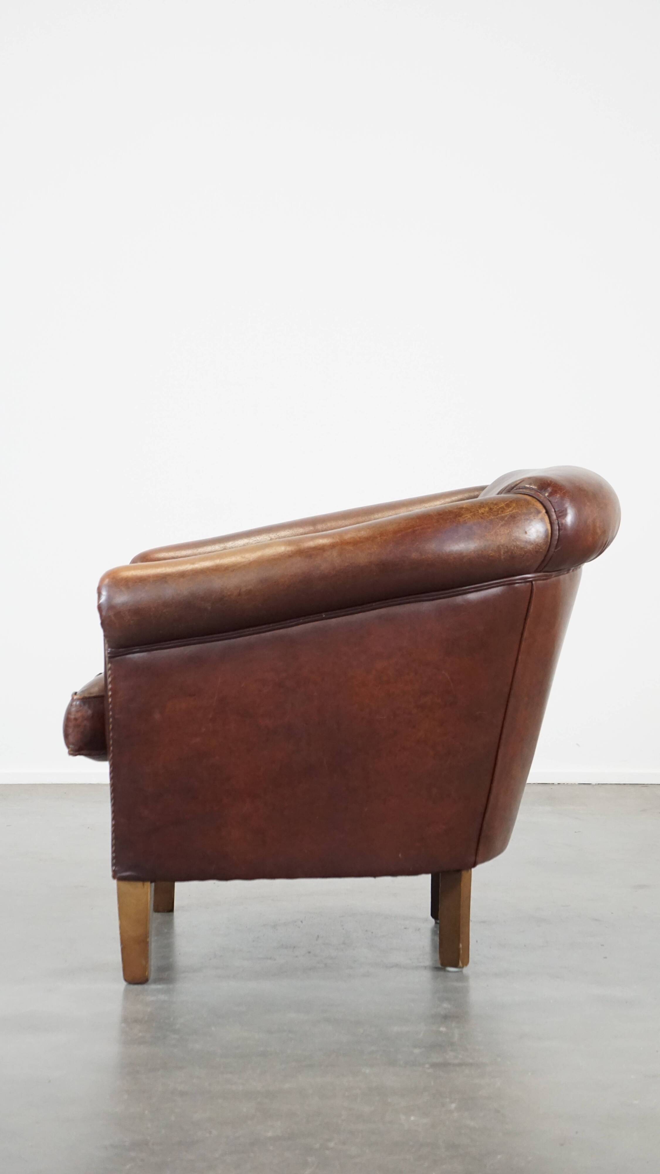 Sheepskin club armchair, correct finishing with decorative nails