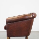 Sheepskin club armchair, correct finishing with decorative nails