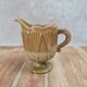 Small antique pressed glass jug in honey colour – moulded decoration