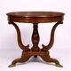 Table ronde Empire – acajou avec incrustations et pieds griffes
