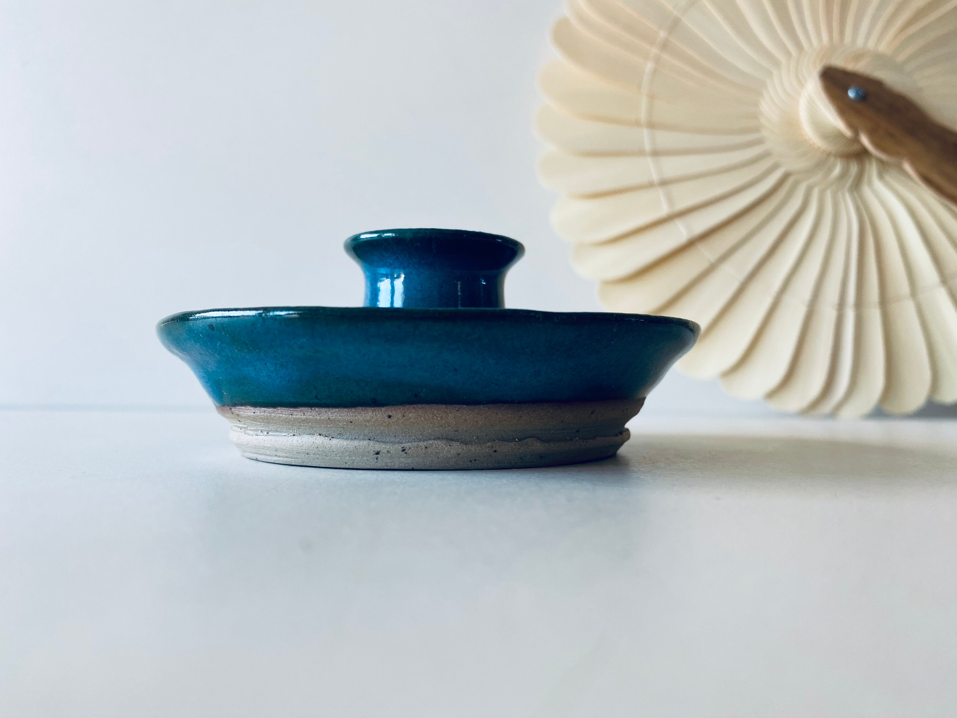Blue enamelled sandstone candlestick
