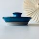 Blue enamelled sandstone candlestick