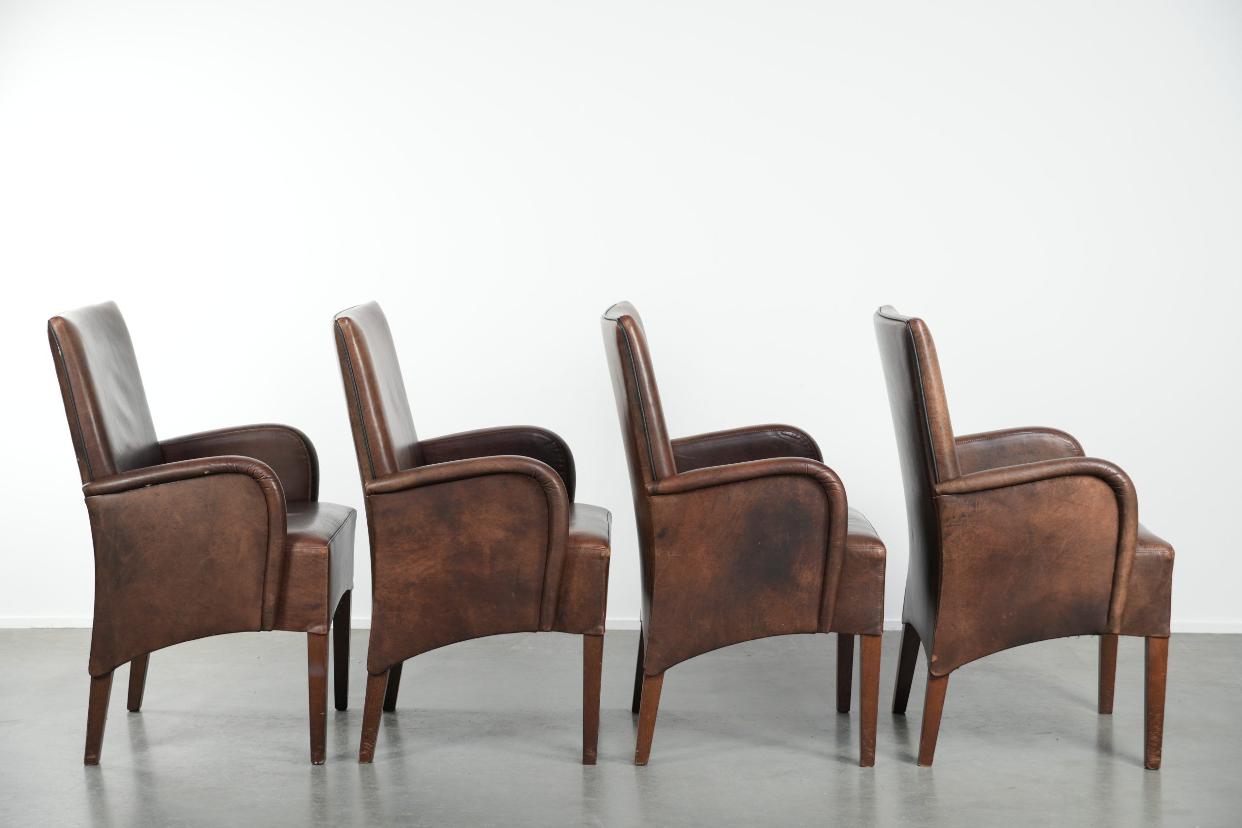 Set of 4 nicely finished dining chairs/side chairs with armrests made of cowhide leather