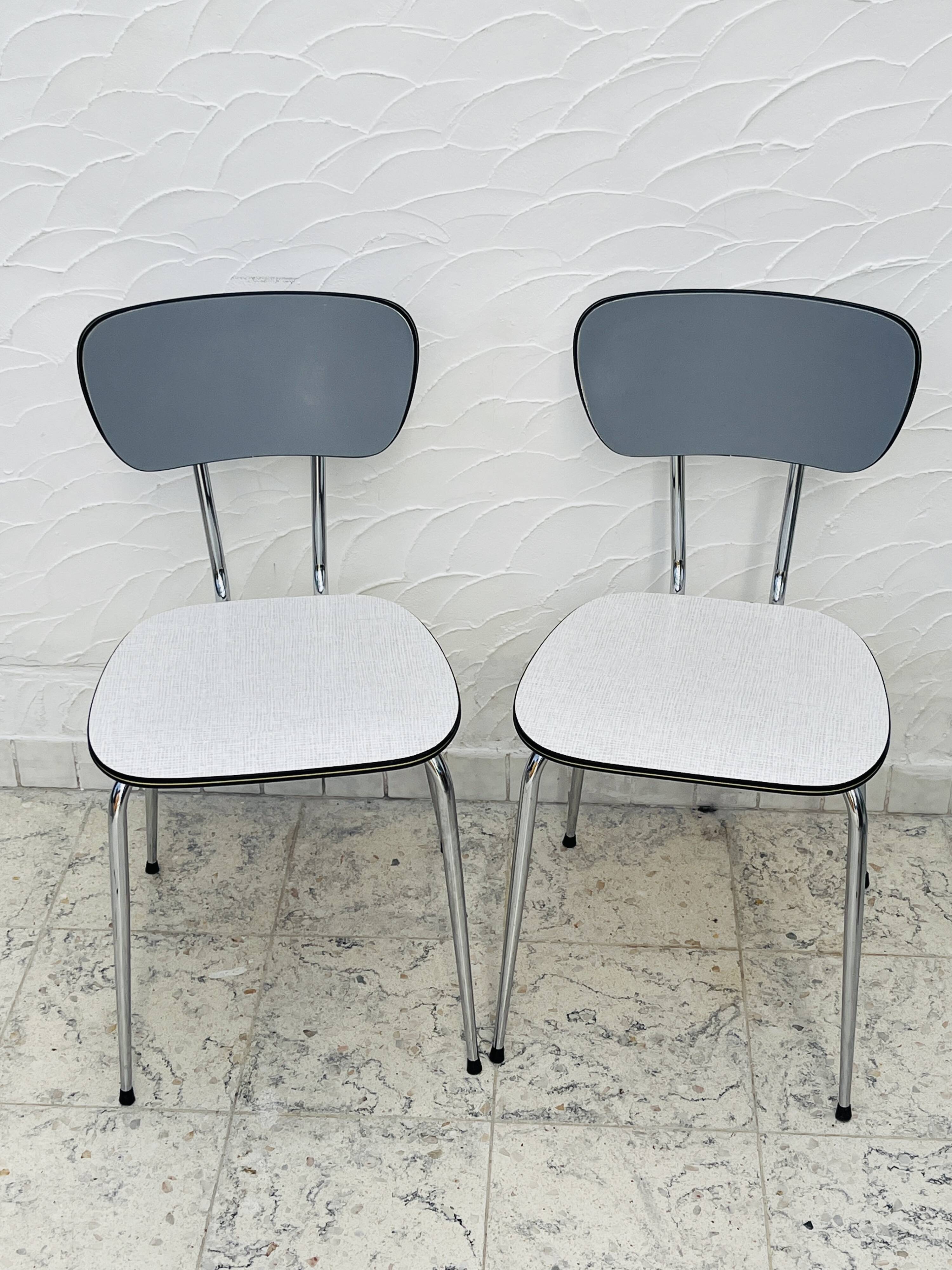 Set of two vintage grey Formica and chrome chairs.