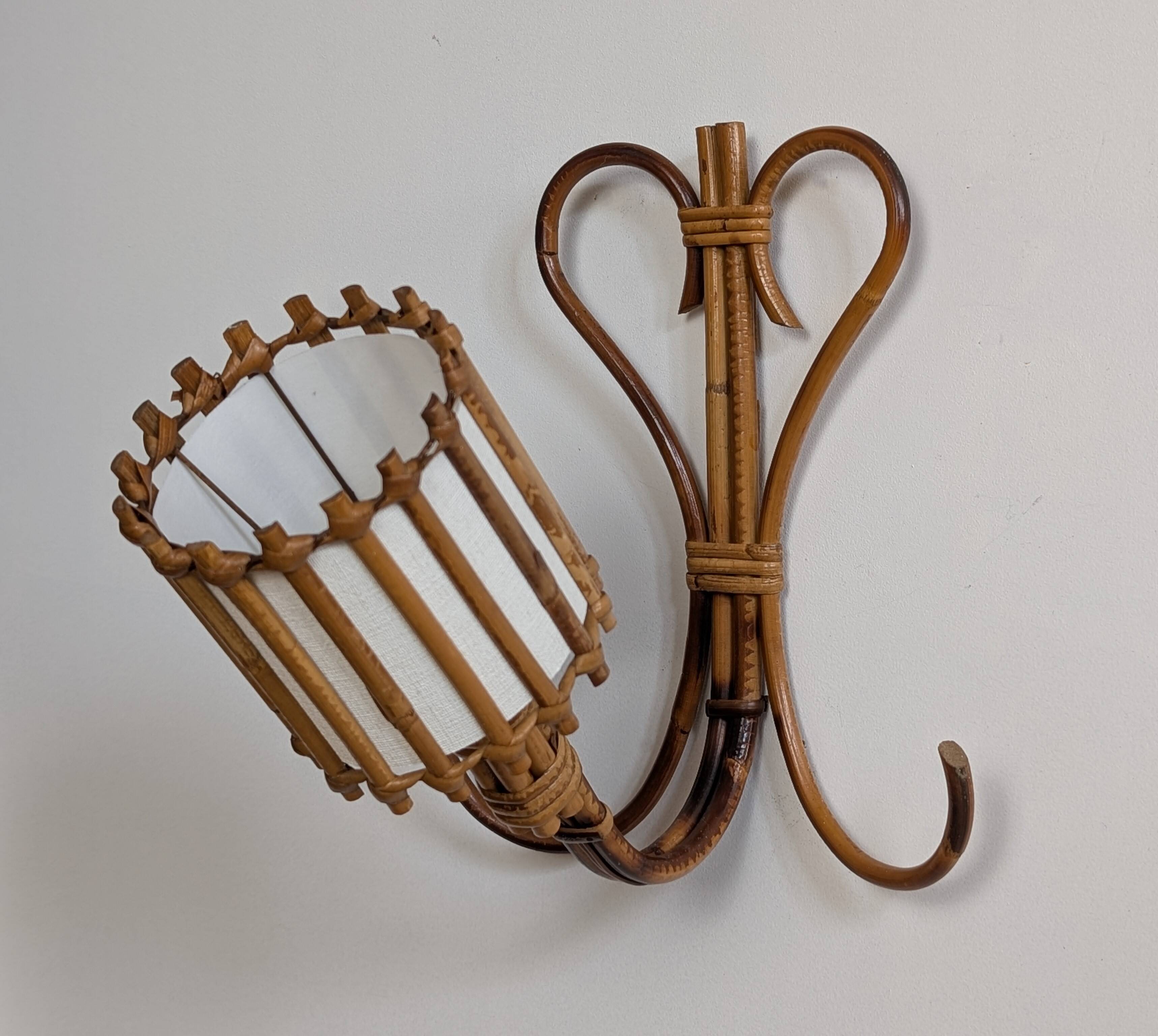 Rattan wall lights by Louis Sognot