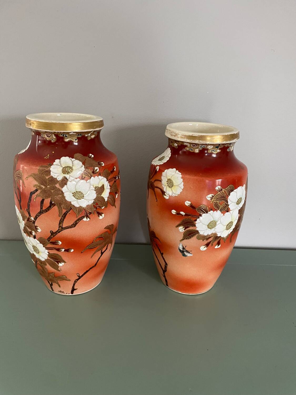 Pair of antique vases with butterfly and flower motif.