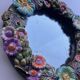 Round wall mirror in ceramic with slip-cast flowers, glazed, from the 60s/70s.
