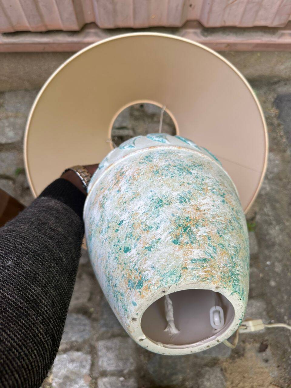 Vintage green ceramic table lamp with a worn lampshade.