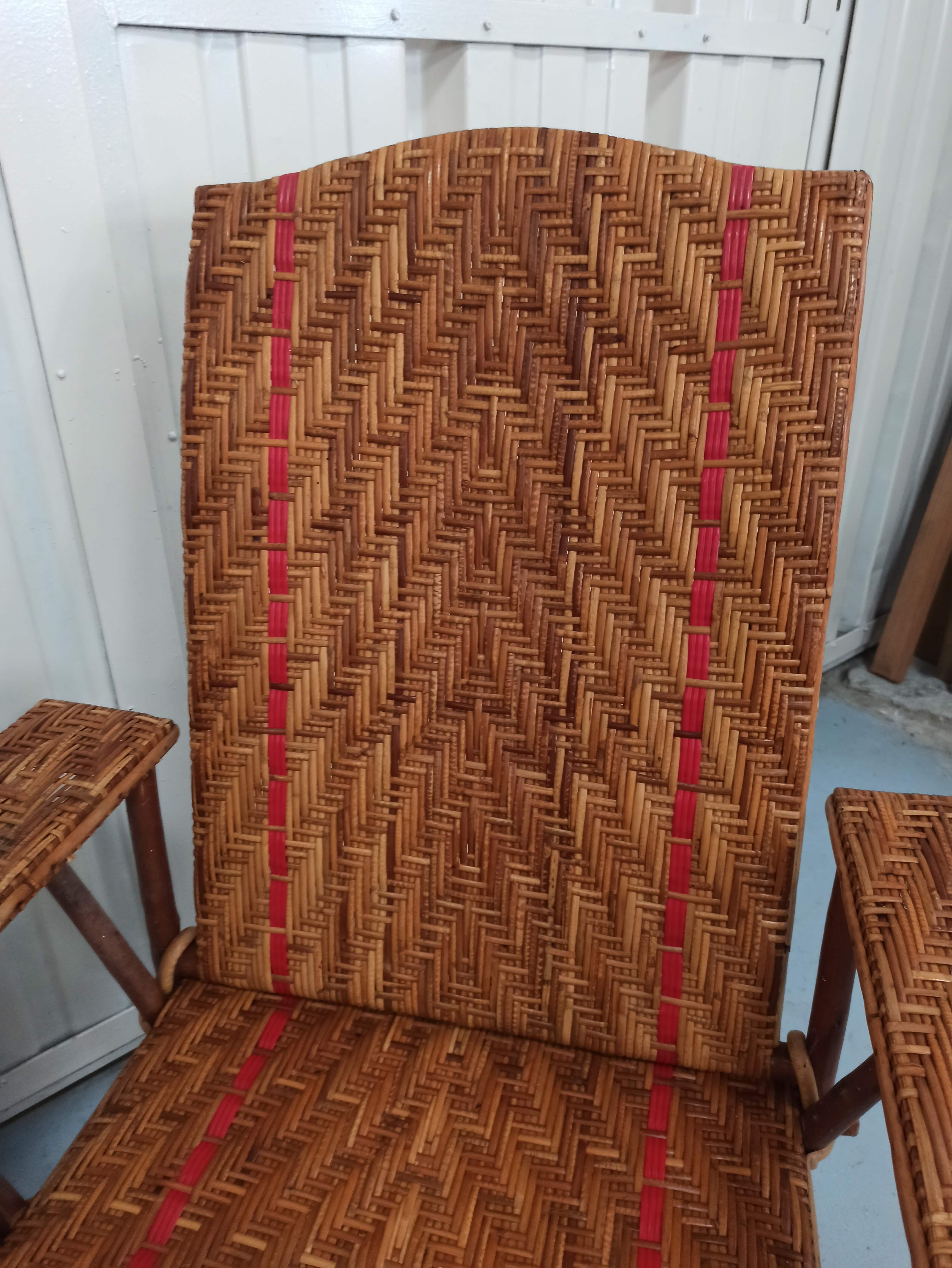 Sunbathing sunbathing in wicker rattan wood deckchair red lounger