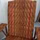 Sunbathing sunbathing in wicker rattan wood deckchair red lounger