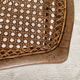 Low wooden stool with caning, footrest.