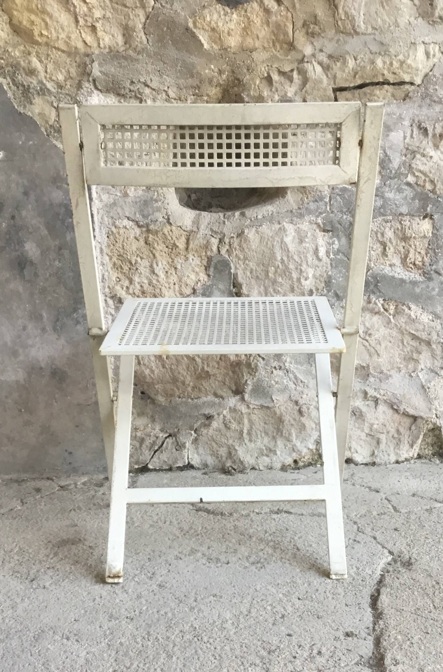 Vintage perforated metal folding chair