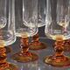 6 amber-footed champagne flutes in very good condition.