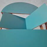 Extendable oval teak dining table