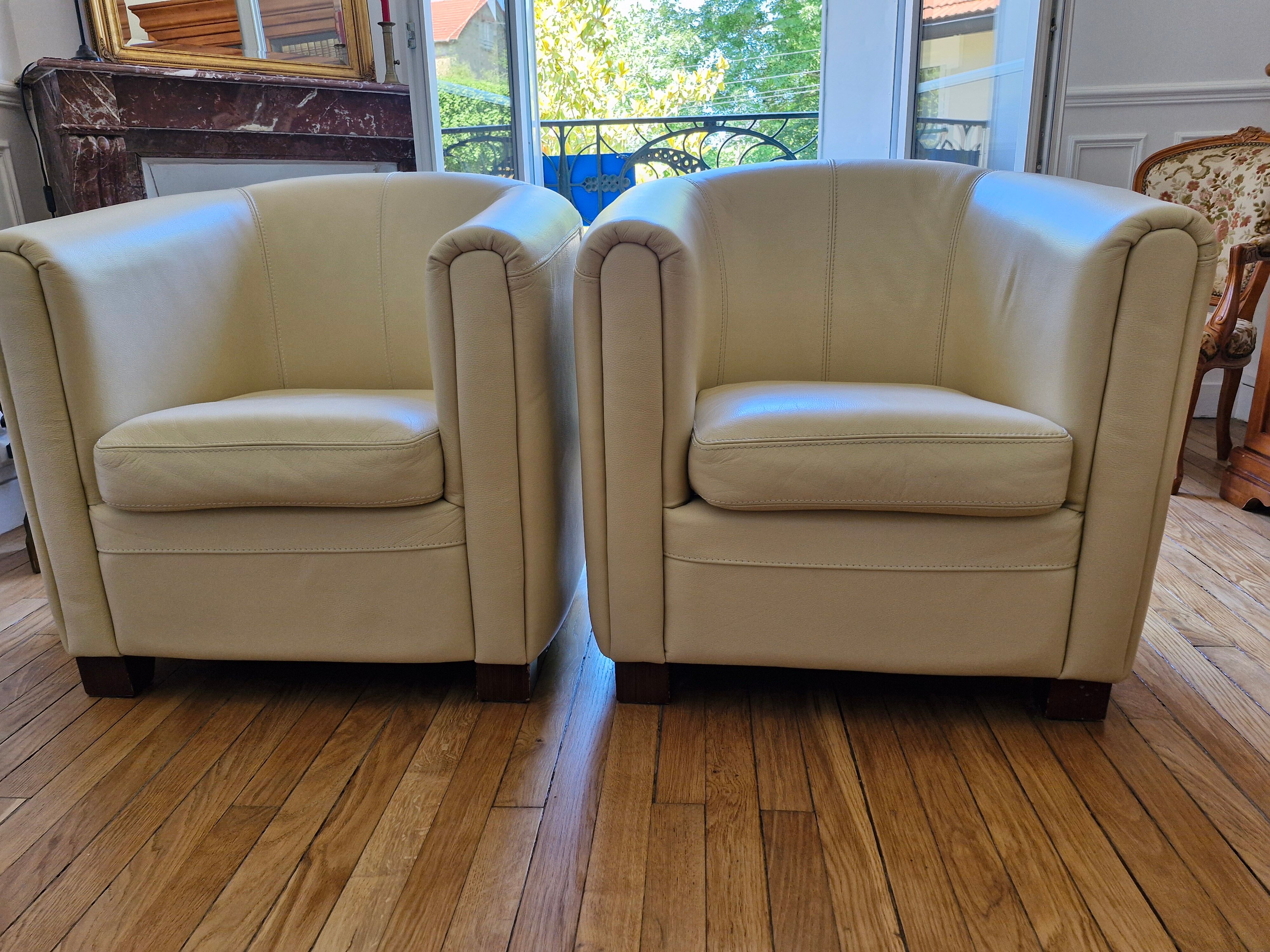 A pair of genuine leather club armchairs.