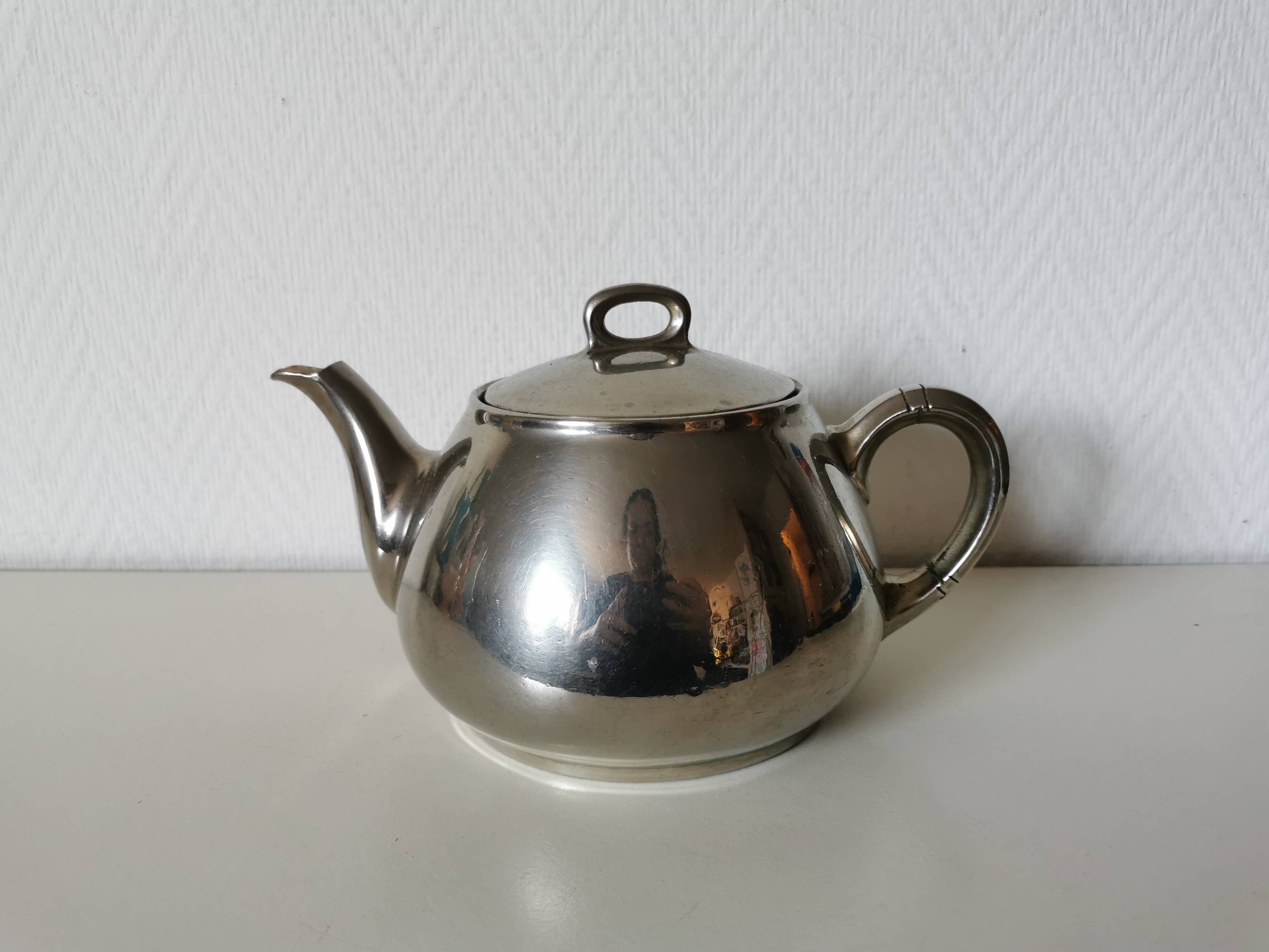 vintage teapot covered with silver metal