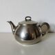 vintage teapot covered with silver metal