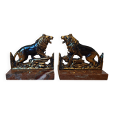 Small roaring lion bookends in patinated metal on a marble base.