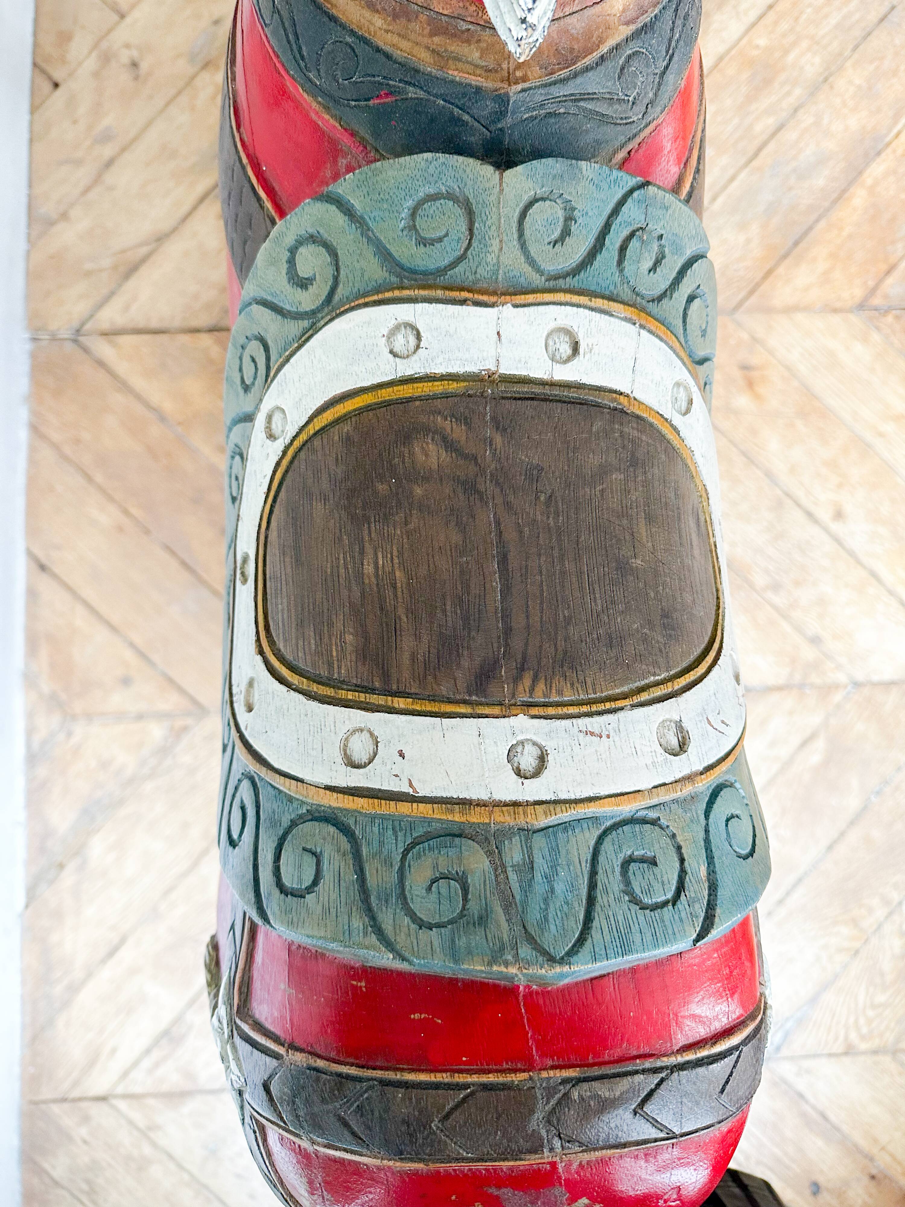 Large decorative rocking horse made of carved and hand-painted wood.