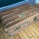 Large antique trunk with a key closure.