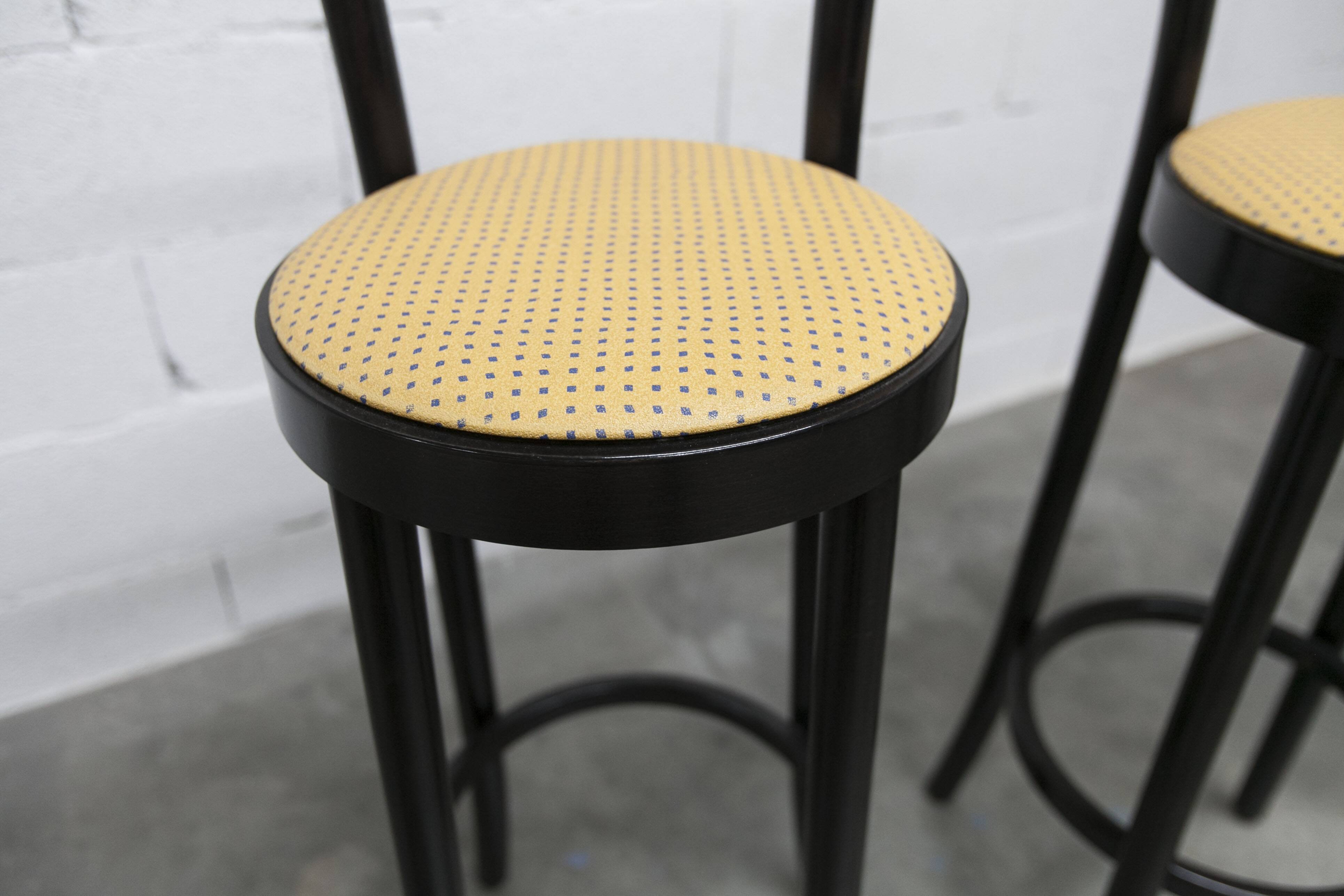 Pair of Baumann stools model Dialog in black and yellow and blue faux leather 1990