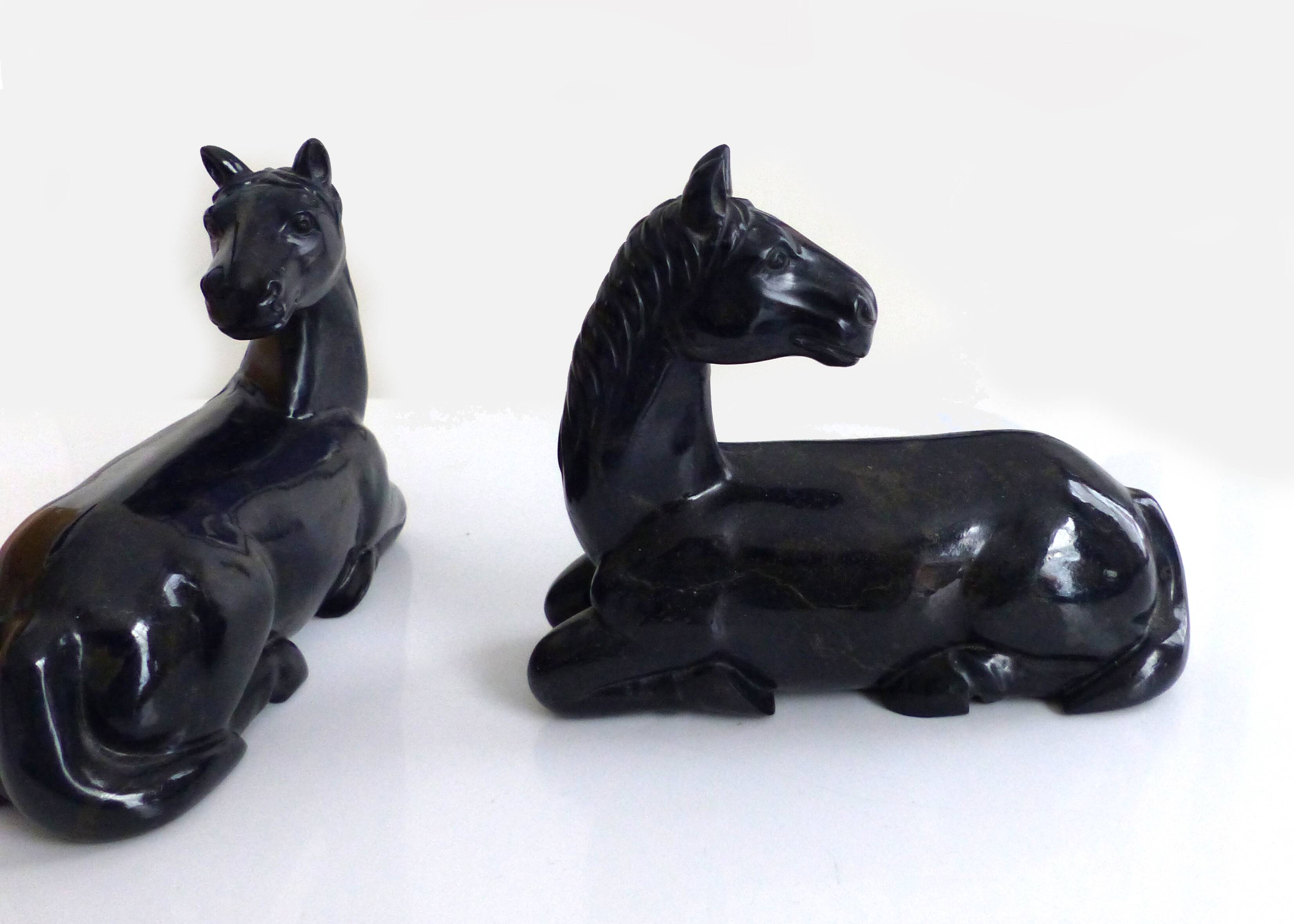 Black marble bookends with lying horses