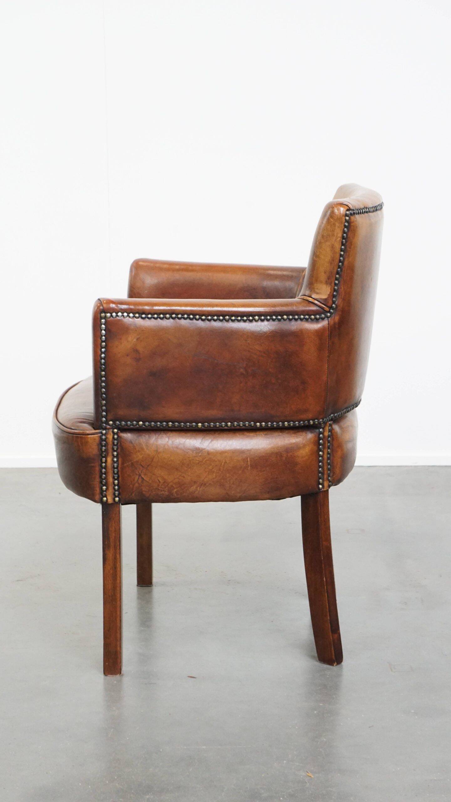 Amazing cognac-coloured sheepskin dining/side chair with armrests