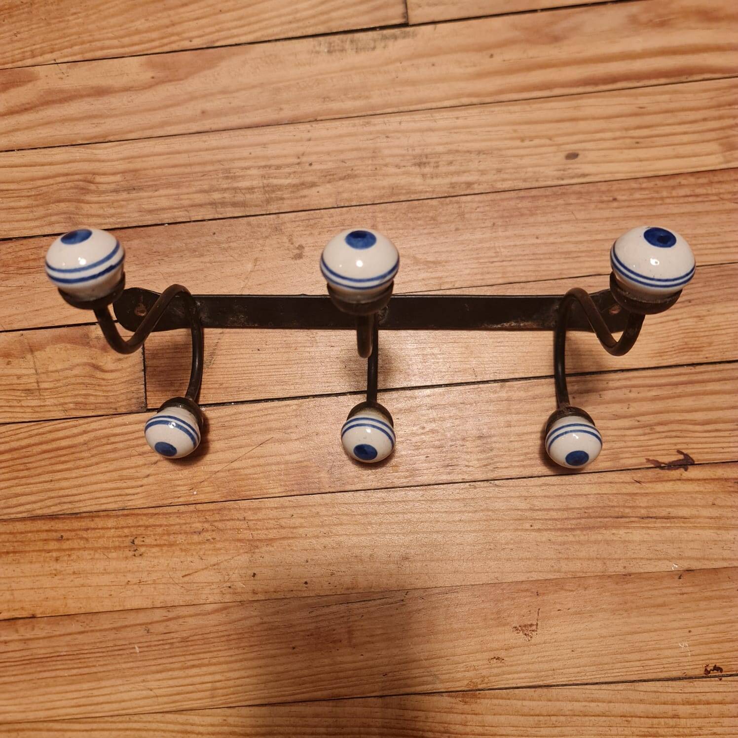 Old iron and porcelain coat hooks