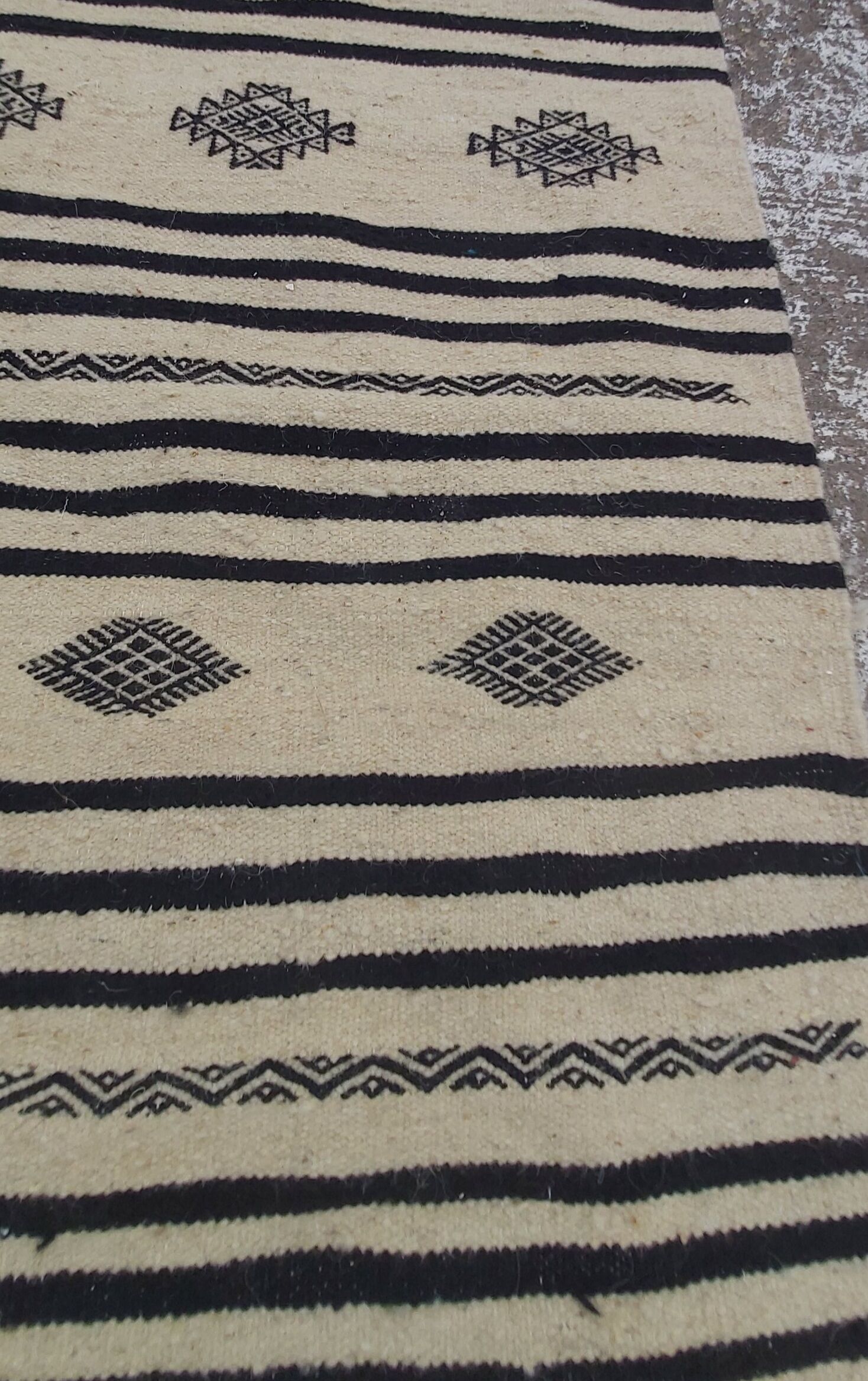 Traditional hand-woven beige and black carpet