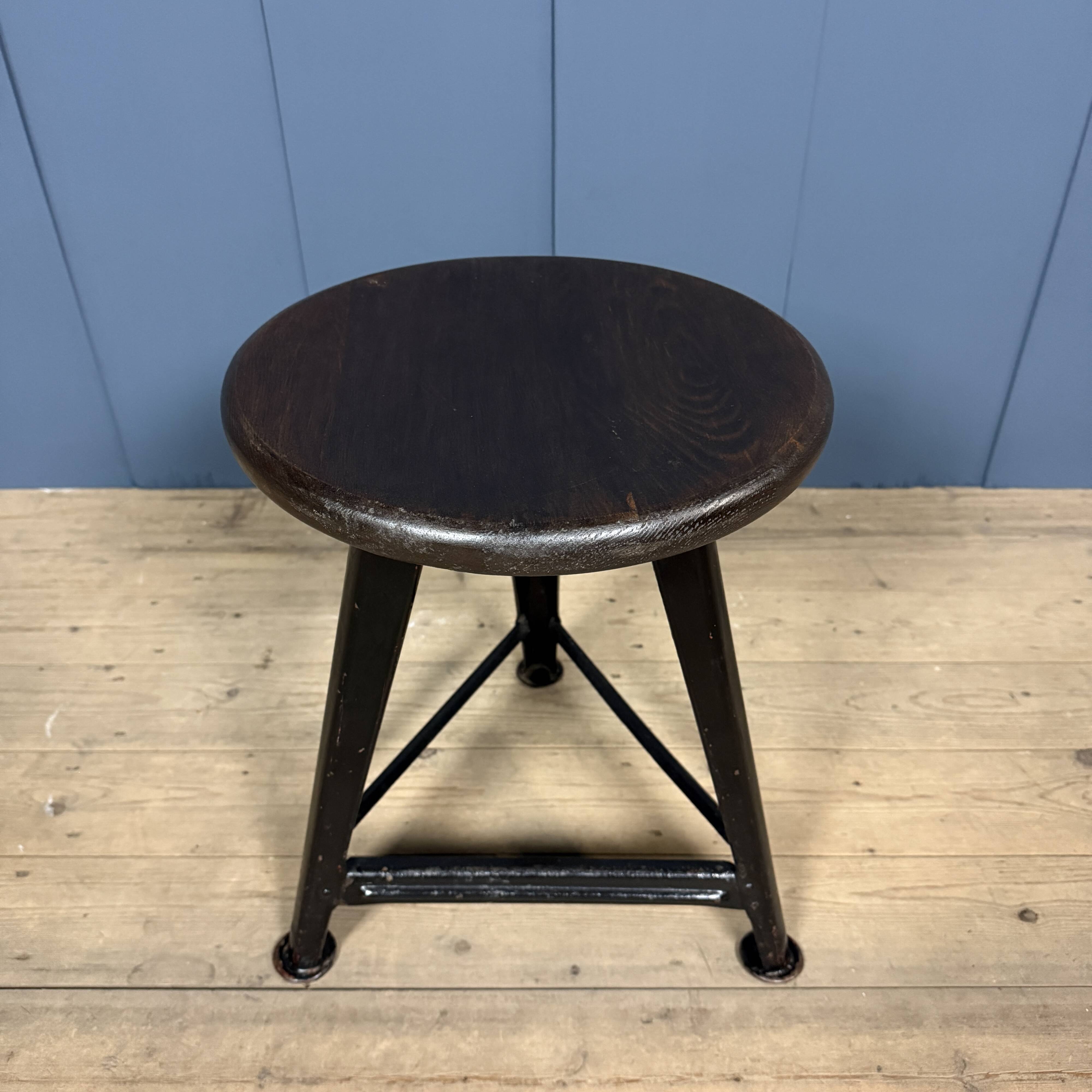 Unmarked black Rowac stool with a dark wood seat.