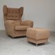 Beige wingback armchair and TVAR footrest, former Czechoslovakia.