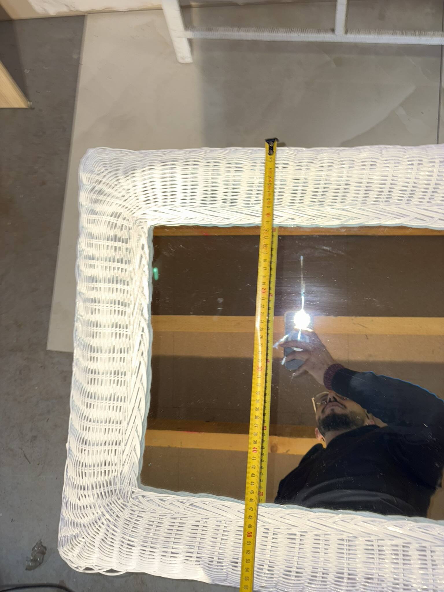 Vintage white rattan mirror with a gothic frame.