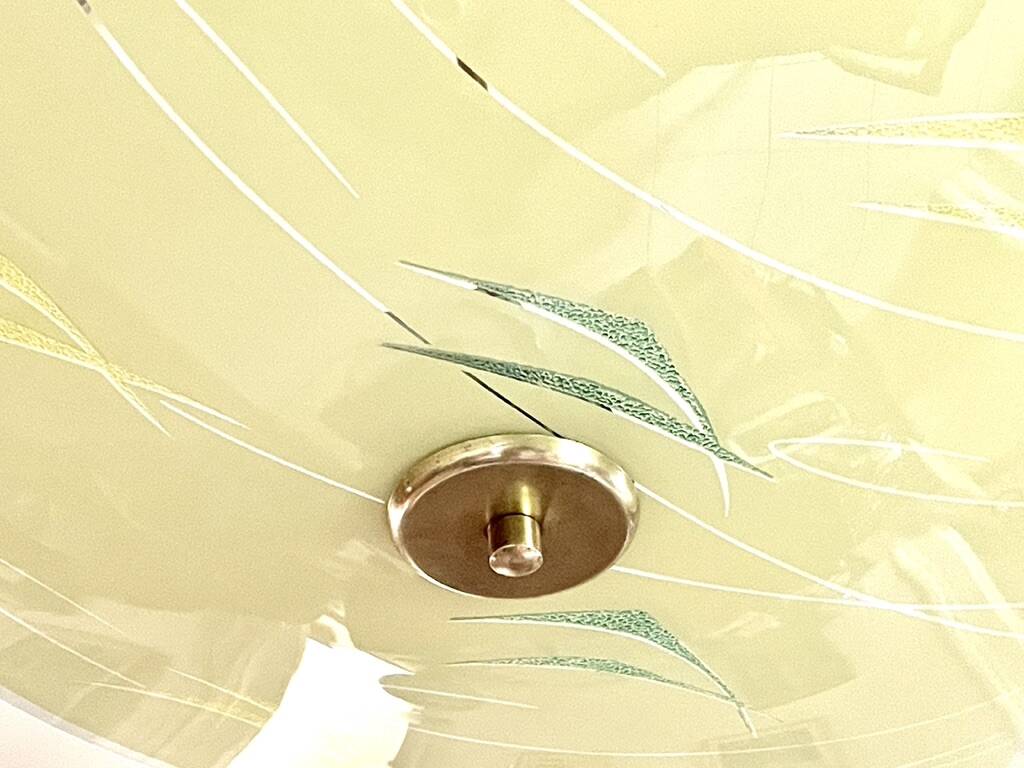 Pale yellow asymmetrical suspension cup 1960