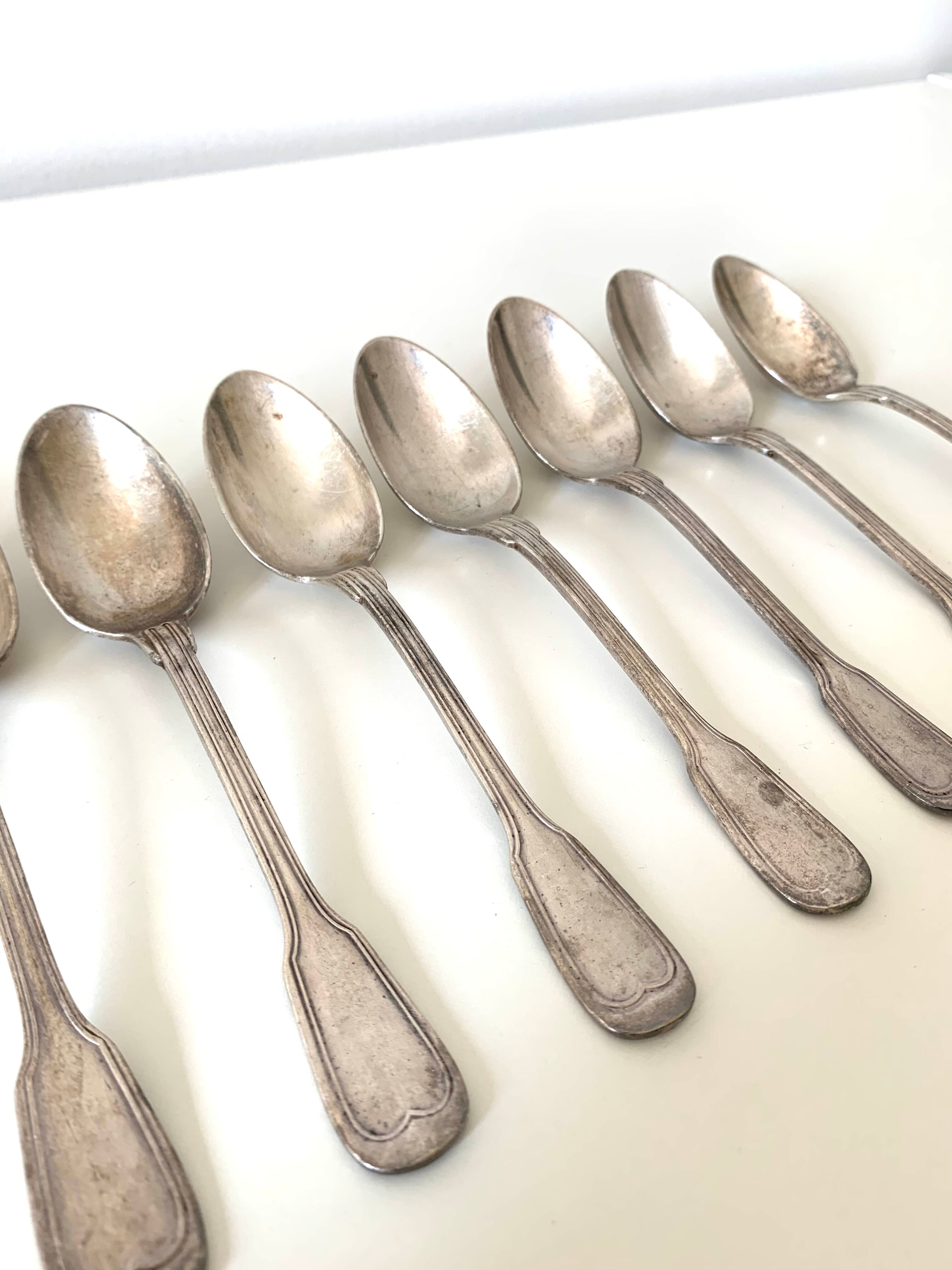 8 silver metal spoons